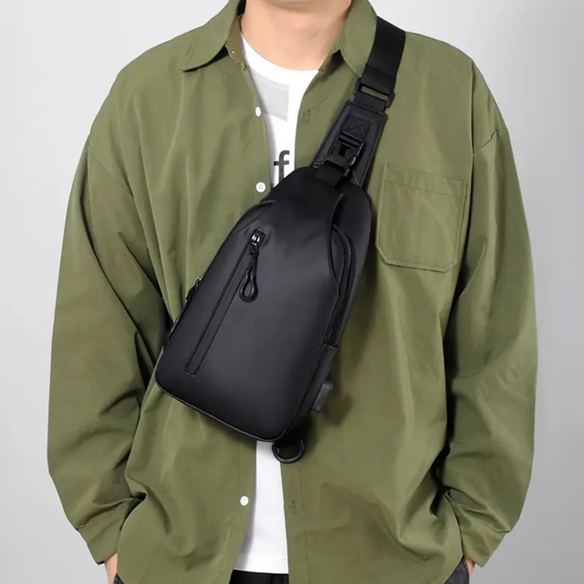 A black minimalist Bearly crossbody sling bag worn diagonally over the shoulder.